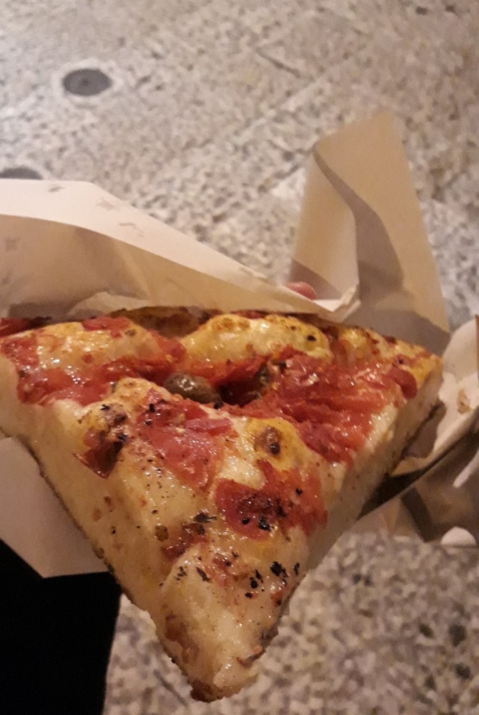 a slice of focaccia barese, a typical snack in Puglia