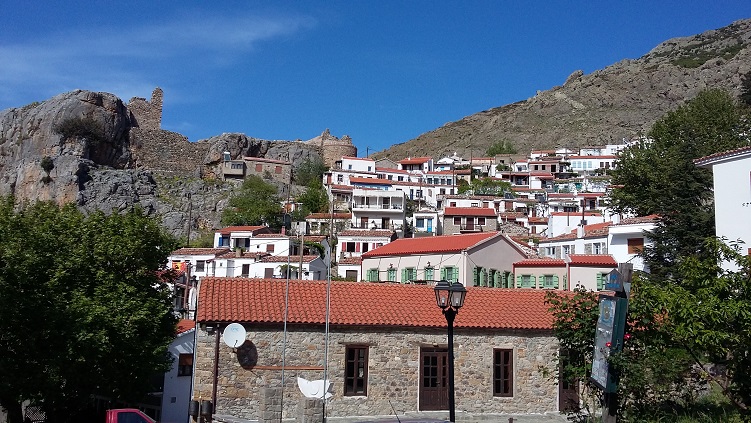 Two-story traditional white houses at the foot of Mount Saos.