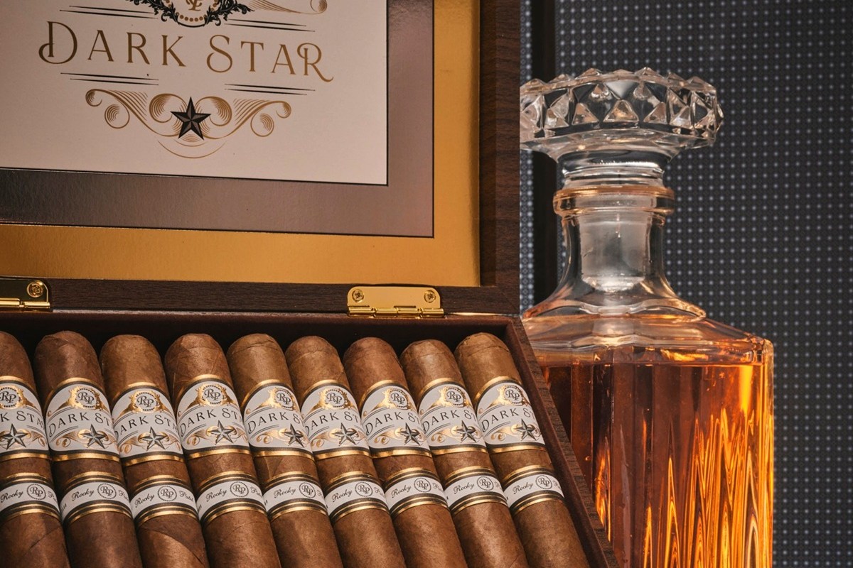 Rocky Patel Dark Star premium cigars with whiskey decanter display