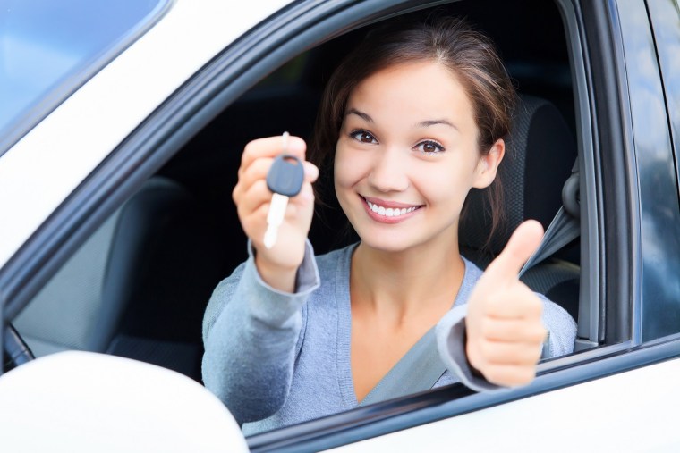 A happy girl in a rented car