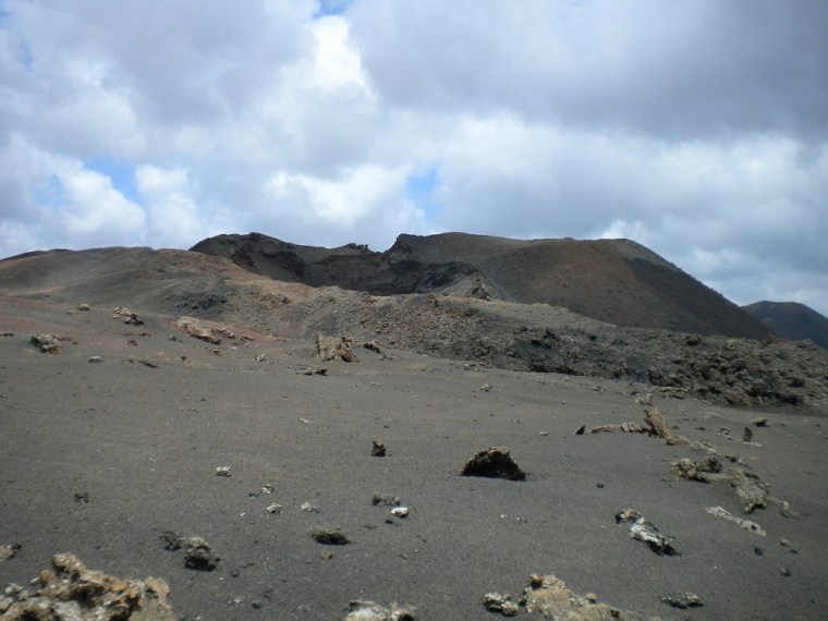 The lunar landscape of Lanzarote: black volcanic sand and volcanic cones.