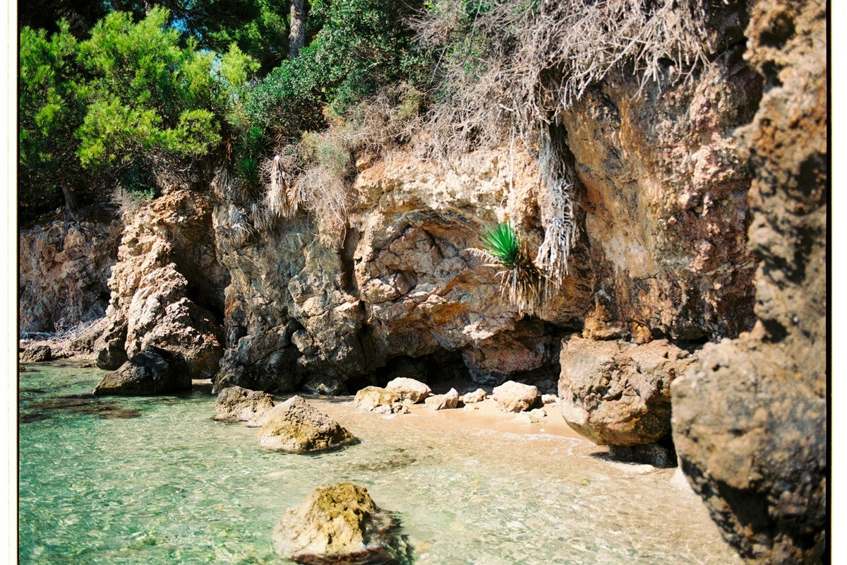 A dramatic rocky cliff and turquoise bay in Mallorca.