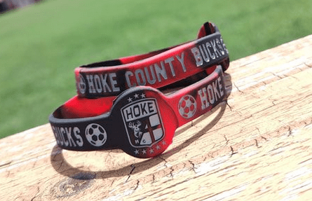 custom sports wristbands on a wooden bench 